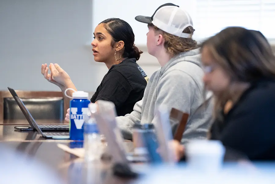 Three students at their desk in class